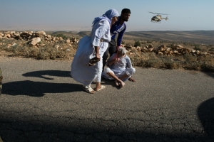 Refugees on Mount Sinjar wait for a rescue helicopter to land. (ADAM MIRANI)