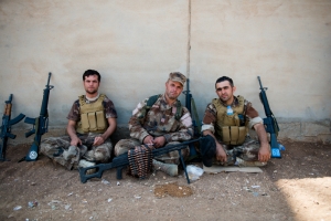 Kurdish soldiers guarding Mount Sinjar pose with their weapons. (ADAM MIRANI)